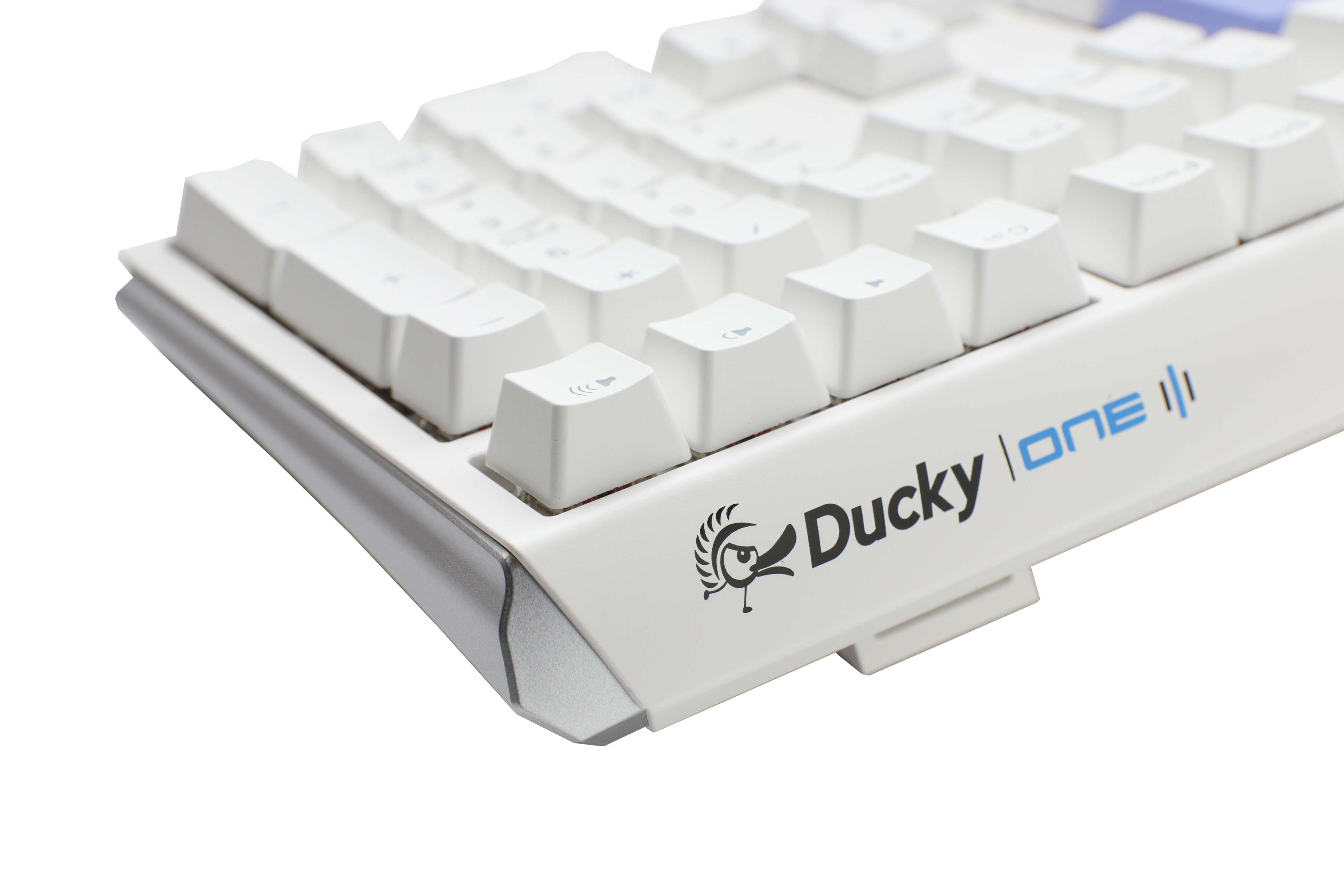 Close-up of a white Ducky One 3 mechanical keyboard with gray and white PBT keycaps on a light gray background. The Ducky logo is visible on the lower right side of the keyboard.